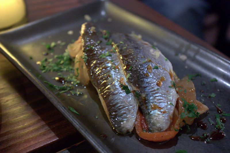 Mercat negre coca topped with escalivada & sardines